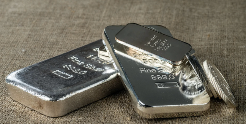 Silver bars and coins in a pile