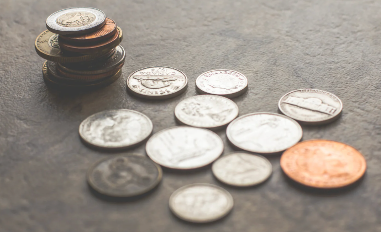 Various coins laid out on a table